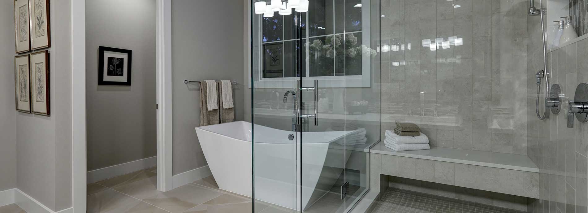 White bathtub and clear glass shower