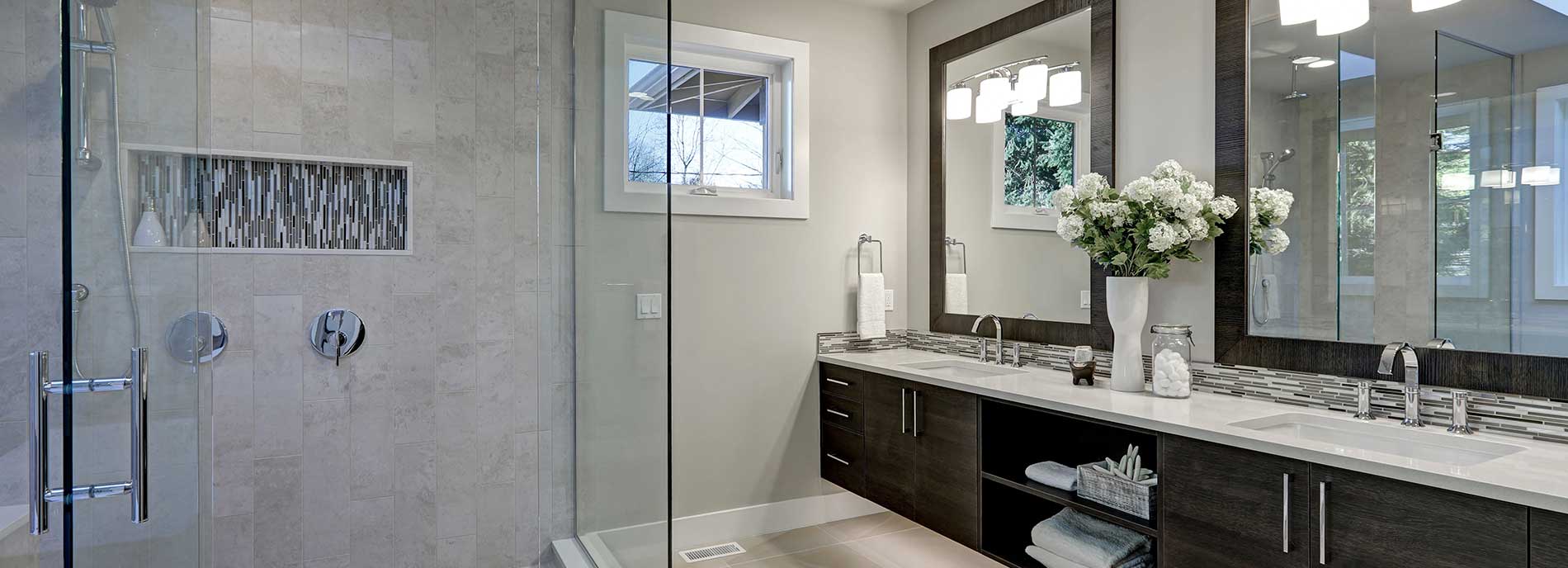 Glass shower and bathroom vanity with large mirrors